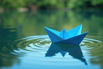 Fototapeta premium Blue origami boat gently rides the ripples of a pond, reflective surface, gentle waves, calm reflections