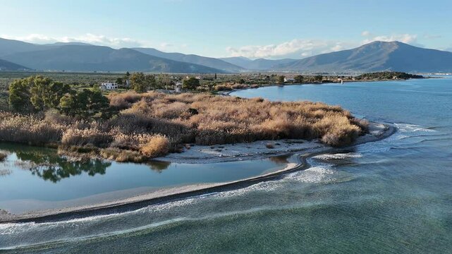 Aerial shot of fresh water inflow into the sea, at the pebble beach of Agios Andreas, Greece