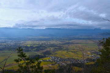 View of Rodine village and farmland in Gorenjska, Slovenia with Jelovica plateau in the background