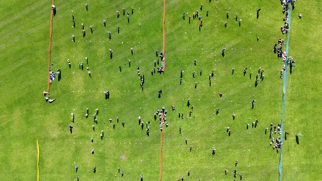 Aerial view of school children playing ball games on a field