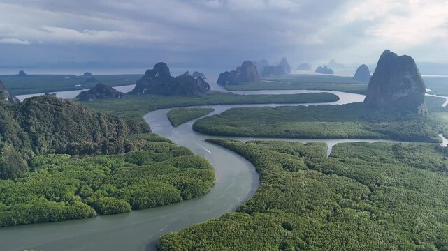 Drone footage of Phang Nga Bay in Thailand, featuring winding rivers, dense mangrove forests, and limestone karsts rising dramatically from the water, creating a breathtaking coastal landscape