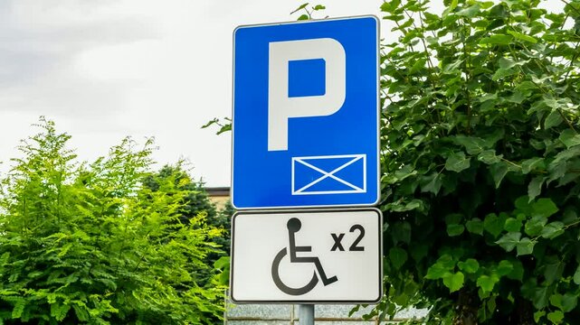 road sign with disabled parking space designation