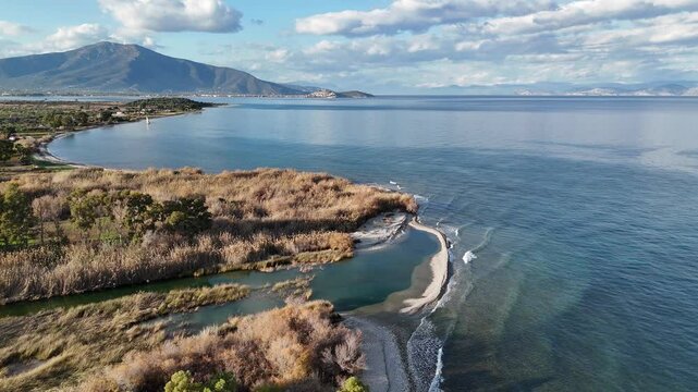 Aerial shot of fresh water inflow into the sea, at the pebble beach of Agios Andreas, Greece