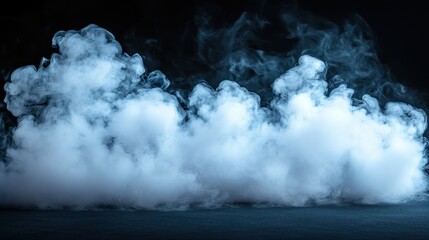 Fototapeta premium Blue smoke swirls on dark studio floor, background black, design element