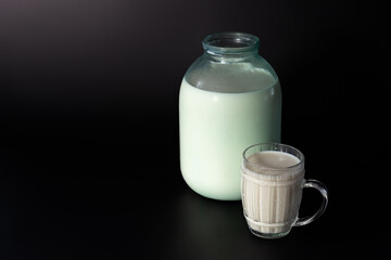 Fresh Whole Milk in Glassware on a Black Background.