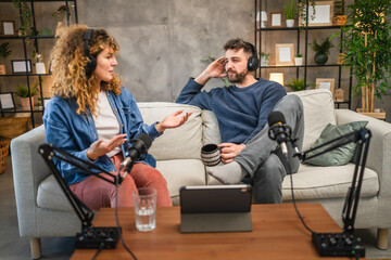 Joyful podcast show hosts record fresh podcast episode in home studio