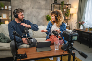 Joyful podcast show hosts record fresh podcast episode in home studio