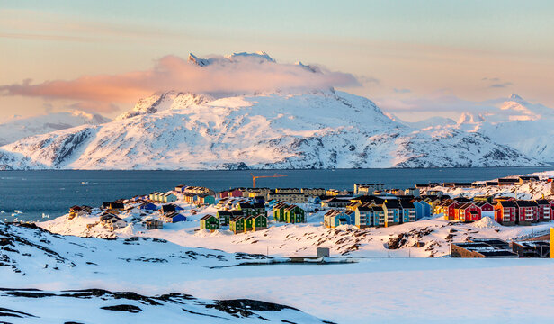 Nuuk city colorful landscape with lots of colorful Inuit houses on the snow hills at the fjord, Sermitsiaq mountain in the background, Greenland