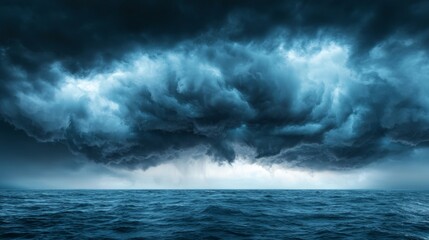 Obraz premium a large stormy sky over the ocean, with dark clouds looming over the horizon and the vast expanse of the sea below