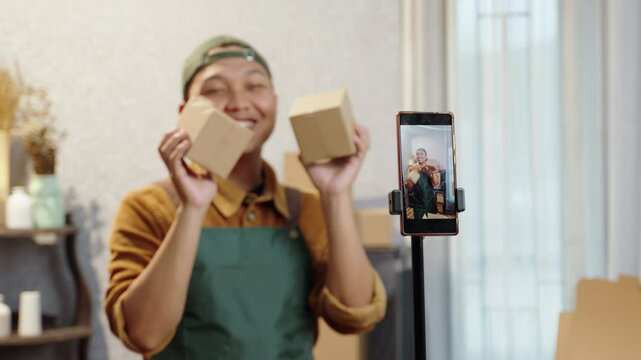 Business owner presenting eco-conscious products during a live stream. Engaging with viewers while showcasing recyclable packaging solutions. Live streaming sales, sustainable products, home office
