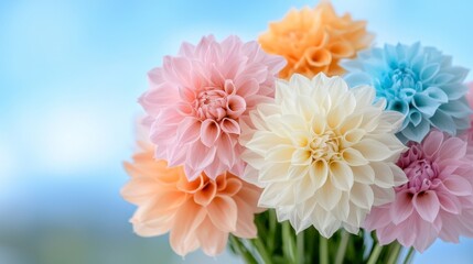 Obraz premium a vase filled with a variety of colorful dahlias on top of a table, with a blurred background