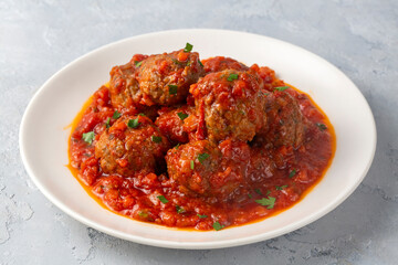 Delicious fresh meatballs in tomato sauce with salt, spices and herbs