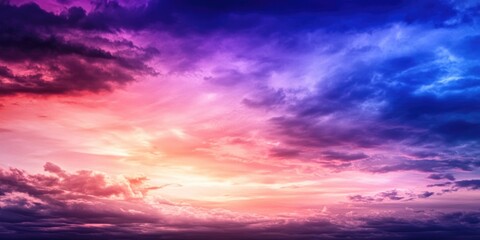 Obraz premium Stunning sunset sky with vibrant pink and blue clouds