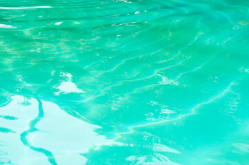Turquoise background of clear turquoise sea water. Idyllic summer vacation. Caribbean sea. Rippled surface. Sea water surface. Ripple water of ocean. Aquamarine nature. Poolside relaxation vibes