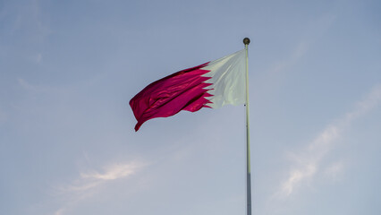 qatar flag flying high in the wind.