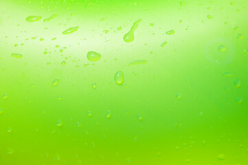 Green background with water drop. Inflatable ring wet in swimming pool. Summer vacation at poolside. Green color of wet background. Drop of water on green inflatable ring in pool