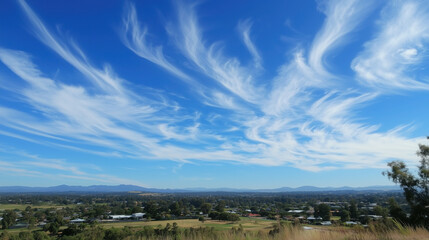 Obraz premium Blue Sky with Wispy White Cirrus Clouds Scattered Across, Creating a Peaceful and Open Atmosphere
