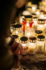 Grave candles in a cemetery at all saints eve.