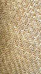 Close-up of a natural woven bamboo pattern in a diagonal design. Perfect for themes of eco-friendly design, traditional craftsmanship, sustainable living, and natural materials in decor or textures.