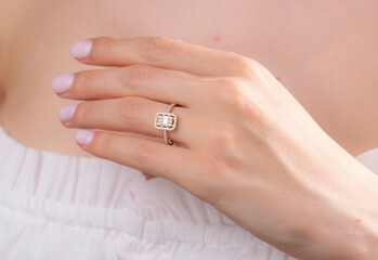 Gold baguette ring on female model finger