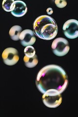 Naklejka premium A collection of colorful soap bubbles float gently in mid-air, ideal for use in illustrations or graphics about whimsy, fantasy, or fun
