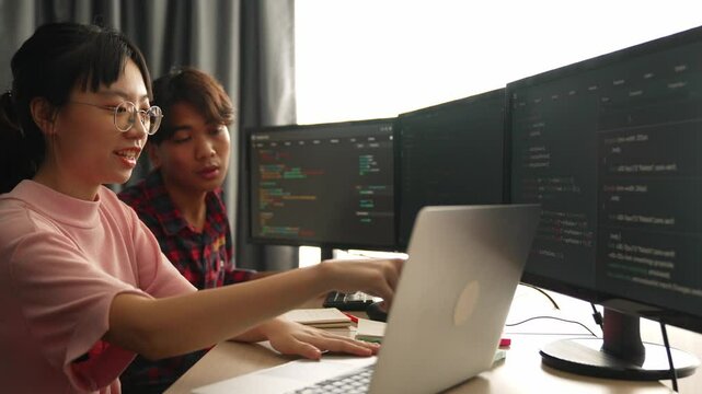 Back end software developer engineer for computer programming working together on debugging writing computing code, solving complex algorithms display on monitor in office. Burgeoning
