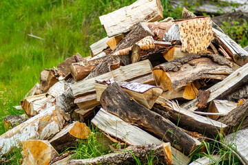 pile of pieces of birch and oak wood, cut and stacked for drying. Background for firewood concept
