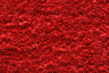 Rich red textured wool fabric background filled with soft fibers