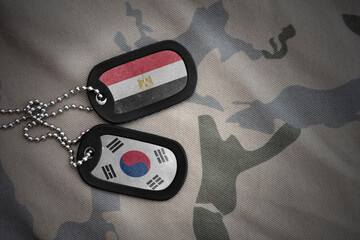 vintage army blank, dog tag with flag of egypt and south korea on the khaki texture background....