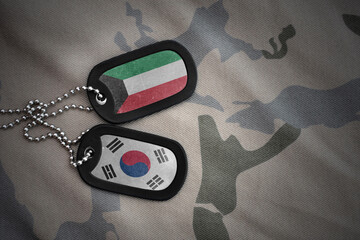 vintage army blank, dog tag with flag of kuwait and south korea on the khaki texture background....