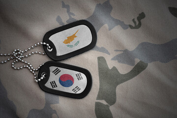 vintage army blank, dog tag with flag of cyprus and south korea on the khaki texture background....