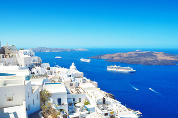 Obraz premium Beautiful View From Fira, Santorini, Greece. Cruise ships in the blue Aegean sea. 