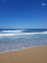 The blue sea, the sky, and the beach