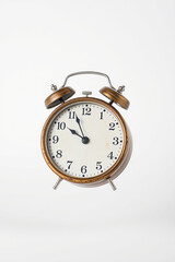 Vintage alarm clock showing eleven o'clock
