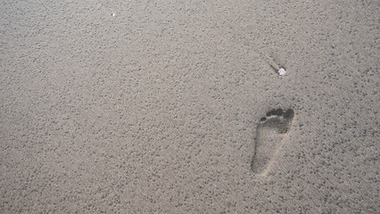 Footsteps on a beach sand barefoot minimalist