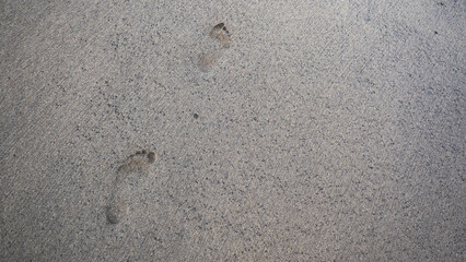Footsteps on a beach sand barefoot minimalist