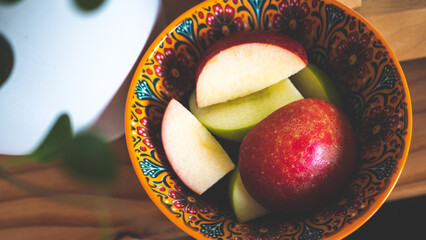 Apples fresh crispy cut in a bowl cozy colourful background fruit