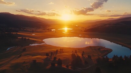 Aerial sunset over tranquil valley lakes and hills.