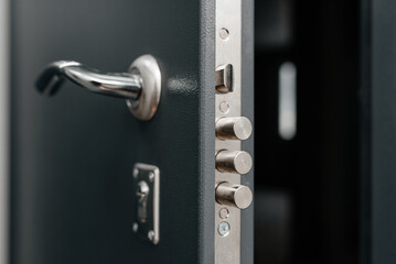 modern metal door to apartment, lock in three rods form, door slightly open, coming home concept