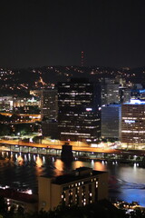 Fototapeta premium Birds eye view of the city skyline of downtown Pittsburgh, Pennsylvania at night.