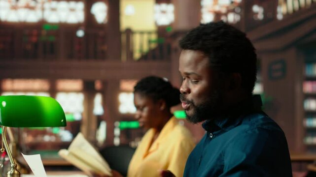 Stressed male student feeling frustrated about the academic struggles of memorizing class notes for upcoming exam. Pupil being upset and worried about his grades, burnout. Camera B.