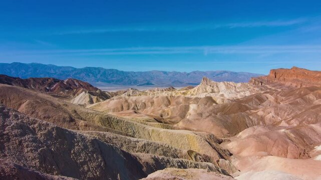 This 4K UHD aerial footage captures the dramatic mountain crest at Zabriskie Point, Death Valley National Park, California. The aerial view reveals the stunning geological formations of the park's ari