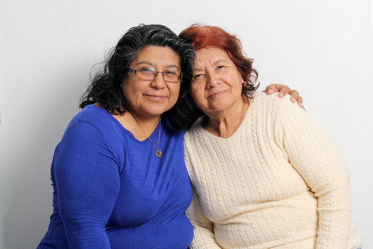 80-year-old mom and 50-year-old daughter brunette Latinas show their love and celebrate Mother's Day