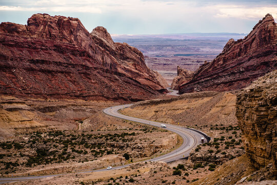 highway wandering through large red rocks in southwestern United States