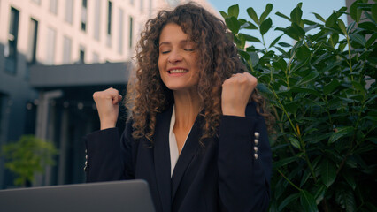 Happy Caucasian young woman girl amazed worker working laptop computer in city celebrate online...