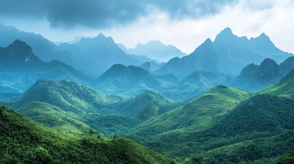 Obraz premium Lush green hills and misty blue mountains.