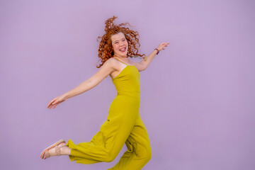 portrait of a beautiful young woman with red hair. Jump. Copy Space. Free Space. Happy.