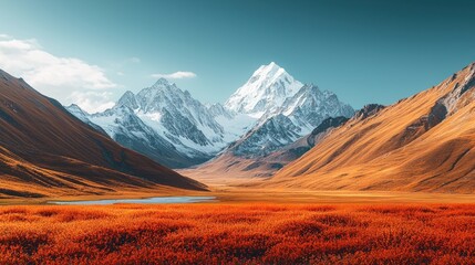 Obraz premium Majestic snow-capped mountain range with autumn meadow and lake.
