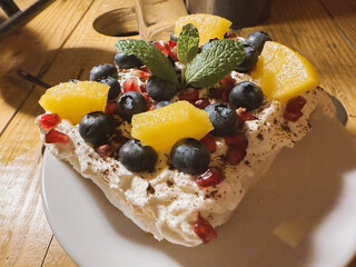 Meringue cake with whipped cream, mascarpone and fruit, a sweet snack