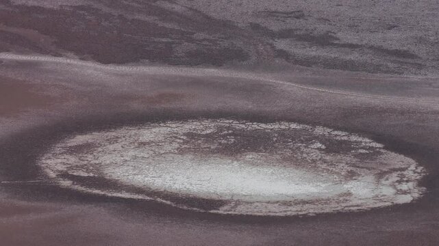 Witness a captivating drone shot of Sandy Swamp Lake in Badwater, Death Valley National Park, highlighting its unique beauty and desert landscape.